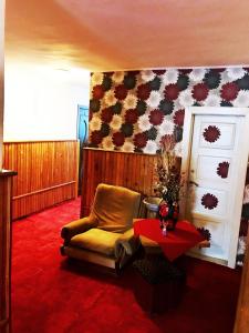 a room with a chair and a table and a flag at Motel Hanul Balota in Drobeta-Turnu Severin