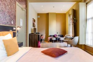 Voodi või voodid majutusasutuse Brasss Hotel Suites toas