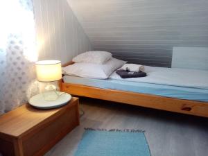 A bed or beds in a room at Kőszeghegyalja Vendégház