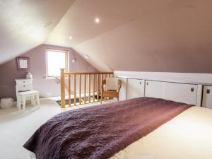 a bedroom with a large bed in a attic at Ettrick Cottage in Port Bannatyne