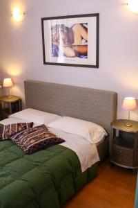 a bedroom with a bed and a picture on the wall at Duca's Guest House in Turin