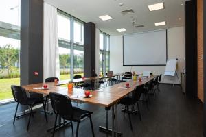 a conference room with a large table and chairs at ONOMO Airport Casablanca in Casablanca