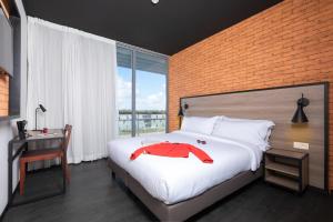 a bedroom with a bed with a red horse on it at ONOMO Airport Casablanca in Casablanca