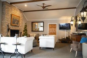 a living room with white furniture and a fireplace at Millsite Lodge in Sandusky