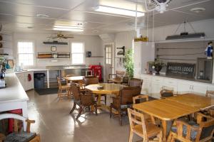 a restaurant with tables and chairs and a kitchen at Millsite Lodge in Sandusky