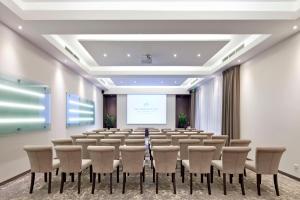 a large room with a lecture hall with chairs and a screen at Metropolitan Boutique Hotel in Krakow