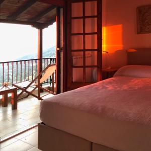 a bedroom with a bed and a balcony at Gaia (Γαία) guest house in Kalamata