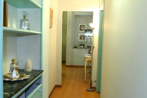 a kitchen with a counter and a room with a table at Duca's Guest House in Turin