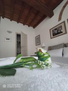 a bedroom with a bed and flowers on the floor at Dante's Relais in Florence