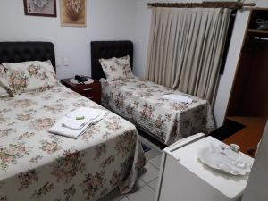 Ein Bett oder Betten in einem Zimmer der Unterkunft Hotel Athenas e Convenções