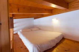 a bedroom with a bed in a room with wooden ceilings at Sea View Apartment Carrapateira in Carrapateira