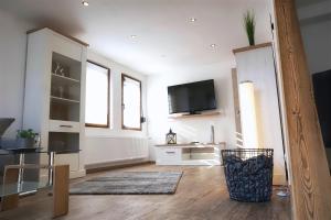 a living room with a flat screen tv on the wall at Ferienwohnung Traumblick in Bernkastel-Kues