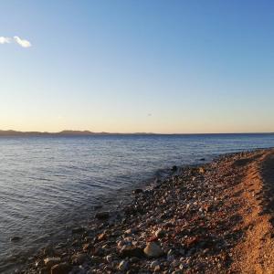 a rocky shore of a body of water at Zen Luxury Apartments in Zadar