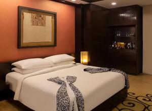 a hotel room with a bed and a dresser at Banyan Tree Cabo Marques in Acapulco