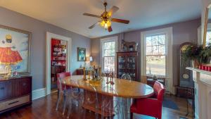 a dining room with a table and red chairs at Gardner Farm Inn in Troy