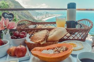 a table topped with a basket filled with food at Mirante do Arvrao in Rio de Janeiro