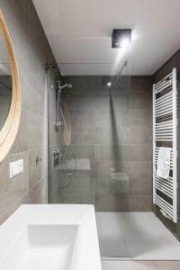 a bathroom with a shower with a sink and a mirror at River Side Residence nr 7 in Oświęcim