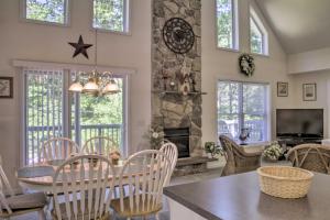 a kitchen and living room with a stone fireplace at Spacious Home with Deck, Grill and Delaware River View in Callicoon
