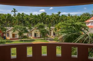 a view from the balcony of a house with palm trees at The Casiita Coorg in Kushālnagar