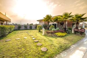 a garden with rocks in front of a house at Martina Hotel Surin in Surin