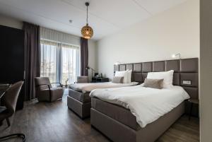 Postel nebo postele na pokoji v ubytování Fruitpark Hotel & Spa