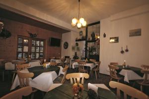 a restaurant with tables and chairs in a room at Pension Barbara in Schierke