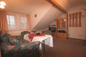 a living room with a table and a couch at Pension Barbara in Schierke