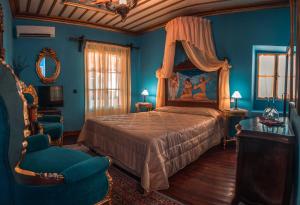 - une chambre bleue avec un lit et une chaise dans l'établissement Ilion Hotel, à Nauplie
