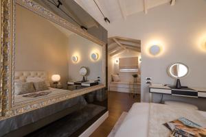 a bedroom with a large mirror and a bed at Castellano Hotel & Suites in Nafplio