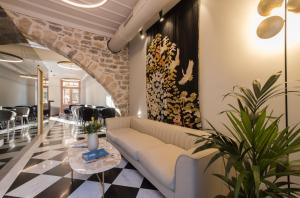 a living room with a couch and a table at Castellano Hotel & Suites in Nafplio