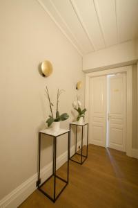 a room with two tables with flowers on the wall at Castellano Hotel & Suites in Nafplio