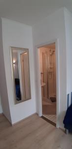 a white room with two mirrors and a bathroom at Zimmervermietung Russ in Equord +26 photos