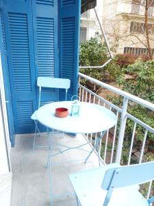 a white table and two chairs on a balcony at SOFOKLEOUS 57, STUDIO KATERINA IN KALLITHEA. in Athens