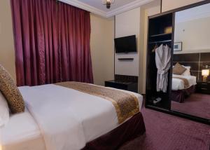 a hotel room with a bed and a television at Platinum Seventy in Jeddah