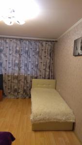 a bedroom with a bed in a room with a window at SavTim Apartaments in Mogilev