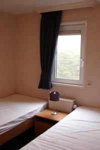 Postel nebo postele na pokoji v ubytování Strandhut 64
