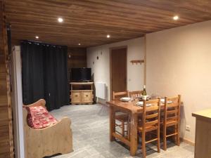 a living room with a table and a dining room at La Datcha 2 - 4 personnes in Bonneval-sur-Arc +10 photos