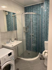a bathroom with a shower and a sink and a toilet at Summer Apartments Kabakum by Flat Manаger in Golden Sands +44 photos