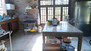 a kitchen with a counter and a refrigerator at Hostel Holztel in Sapiranga