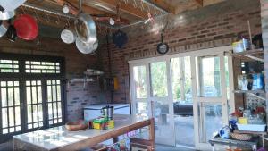 a kitchen with a table and a brick wall at Cabana do Lago in Sapiranga