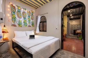 a bedroom with a bed with a laptop on it at Tam Coc Brothers Homestay - Ninh Bình in Ninh Binh