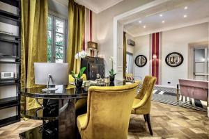 a dining room with a glass table and yellow chairs at Arte' Boutique Hotel in Florence