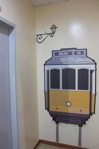 a painting of a train on a wall at O Elétrico Guesthouse in Lisbon