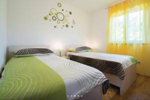 een slaapkamer met 2 bedden en een raam bij Comfortable apartment in Bartići in Labin