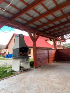 a pizza oven sitting under a cover in a patio at Dom u Kasi in Podwilk