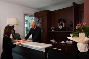 a man and a woman standing at a table at Hotel Residence Villa Del Mare in Rimini +37 photos