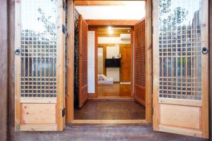 an open door to a room with a hallway with fences at GaEunChae 2 in Jeonju