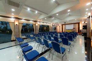 una sala de conferencias con sillas azules y una pantalla en Martina Hotel Surin, en Surin