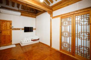 an empty room with a tv and a door at GaEunChae 2 in Jeonju