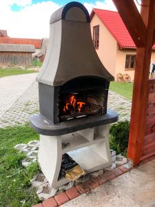 a stone oven with a fire inside of it at Agroturystyka Kasia in Podwilk